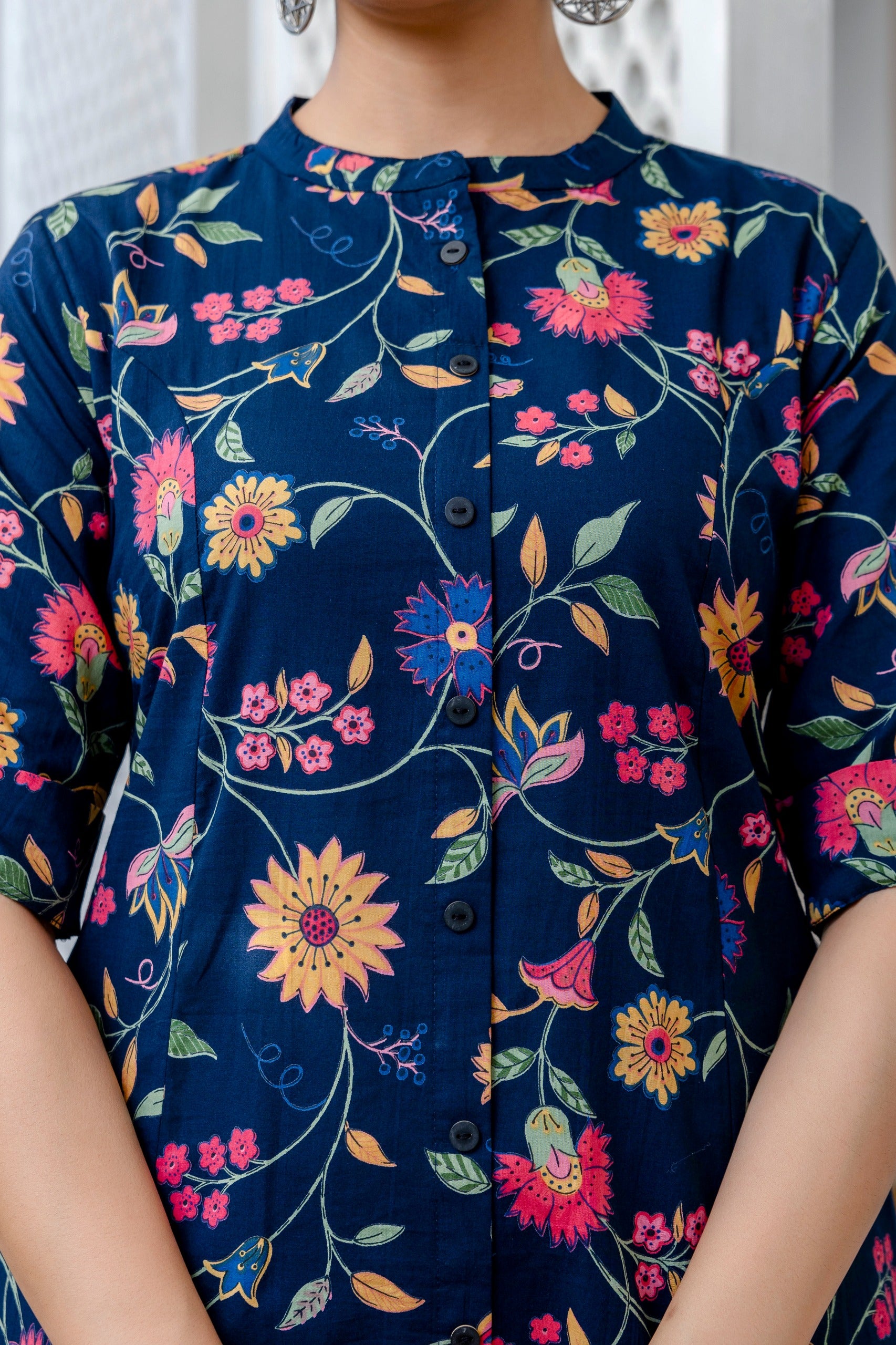 Navy blue dress with colorful floral pattern worn by a person
